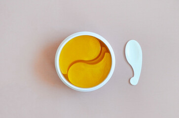 gold hydrogel eye patches with collagen, mask and moisturizing of the skin under the eyes, the concept of women's care for the beauty