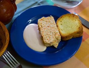 Portion of fresh fish pate with toasted bread and sauce