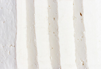 A texture of sliced white tofu close-up, top view.
