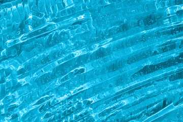 Clear transparent skincare product sample closeup. Blue gel texture. Hand sanitizer, alcohol gel, moisturizer swatch. Hyaluronic acid gel. Emulsion, anti aging woman cosmetics product.