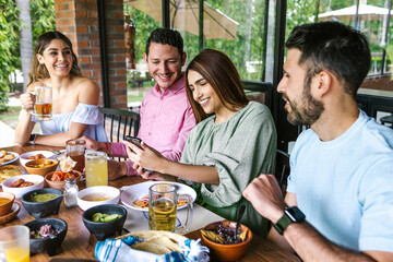 Group of latin friends eating mexican food in the restaurant terrace in Mexico Latin America	