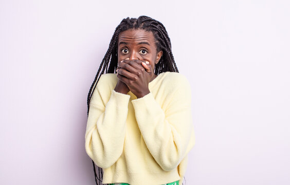 black pretty woman covering mouth with hands with a shocked, surprised expression, keeping a secret or saying oops
