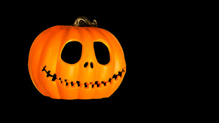 Isolated Pumpkins head Jack-o'-lantern close-up on black background banner with copy space