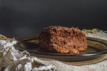 chocolate cake with chocolate filling, copy space, black background and selective focus