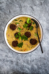 vegan green curry with mixed vegetables and plant-based meatballs, healthy plant-based food