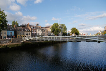 Fototapeta na wymiar Cork City, Cork, Ireland: July 31, 2021: Pedestrian bridge over River Lee in Cork City, Ireland