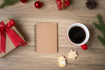 Blank notebook, black coffee cup, Christmas cookies and pen on wood table, Top view and copy space. Xmas, Happy New Year, Goals, Resolution, To do list, Strategy and Plan concept