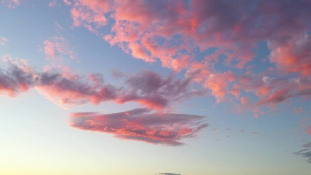 Beautiful pink fluffy clouds at sunset, skyscape background