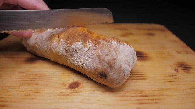 cut bread with chourizo with knife slow motion