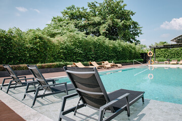 Swimming Pool Ladder and Sun Lounger in Poolside, Luxury Outdoor Swim Pool and Modern Decoration of Resort Hotel. Relaxation Swimming Pool in Summer Holiday and Leisure Vacation Lifestyles.