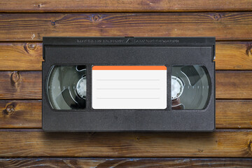 video cassette, video tape on wooden table
