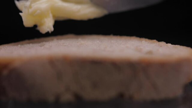 spread butter on bread with knife slow motion
