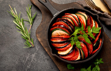 Ratatouille casserole on dark background.