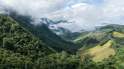 Naklejka premium A beautiful mountain valley view with a road passing through. Beautiful road in Nan Province, Thailand
