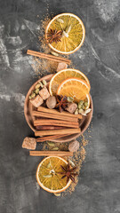 A set of spices for mulled wine. Cinnamon sticks, anise stars, nutmeg, brown sugar. Copy space.