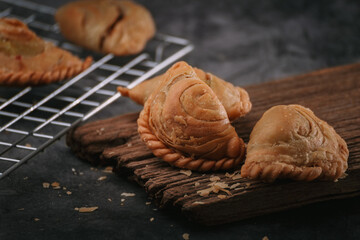 Delicious homemade curry puff on dark background.
