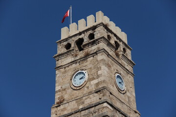 Obraz premium old turkish tower with clock on a blue sky background