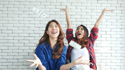 Happy young asian woman holding dollar money and throw in the air celebrate happiness dance wealth...