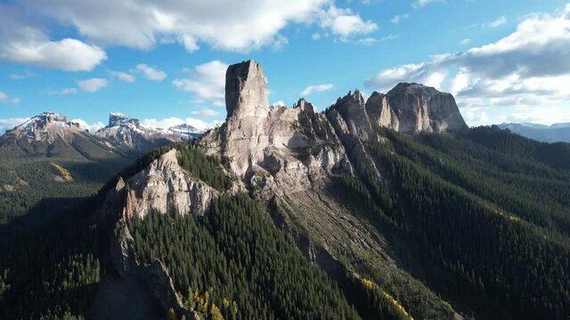 Aerial video of epic rocky ridge and mountain peak in the dramatic afternoon sun. Cinematic drone footage filmed in the Colorado Rocky Mountains.