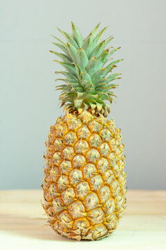 Ripe pineapple isolated on wooden table