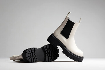 White Trendy boots. fashion female shoes still life - obrazy, fototapety, plakaty