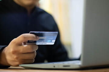 man hand using mobile smart phone, online payment, banking and online shopping at the home.