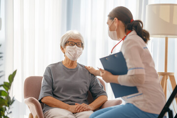 Fototapeta premium Doctor and senior woman wearing facemasks