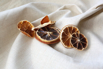 dried lemon wedges on a light fabric background. There is room for text.