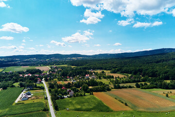 Mountain village with forests, bird eye view. Sleza mountain landscape near Wroclaw in Poland. Nature background, aerial view.
