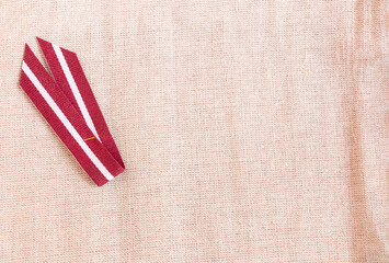 red and white ribbon on linen fabric, symbol of the day of the proclamation of the republic, independence of the republic with place for text - obrazy, fototapety, plakaty