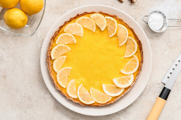 Plate with tasty lemon pie on light background