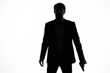 Man gun in the hands of the emotions silhouette posing studio
