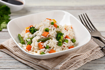 Bowl with tasty rice and vegetables