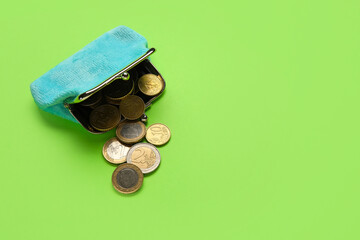 Blue wallet with coins on green background - obrazy, fototapety, plakaty