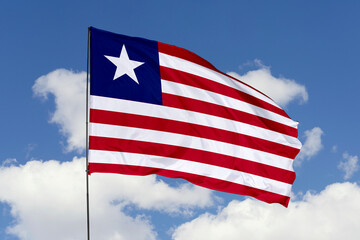 Liberia flag isolated on the blue sky background. close up waving flag of Liberia. flag symbols of Liberia. Concept of Liberia.