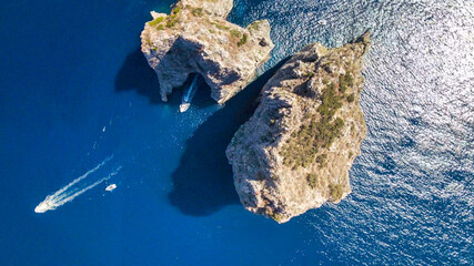 Amazing aerial view of Faraglioni Rocks over the sea in Capri Island, Italy. Drone viewpoint