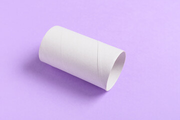 Toilet paper cardboard tube on color background