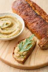 Tasty sandwich with baba ghanoush on wooden background, closeup