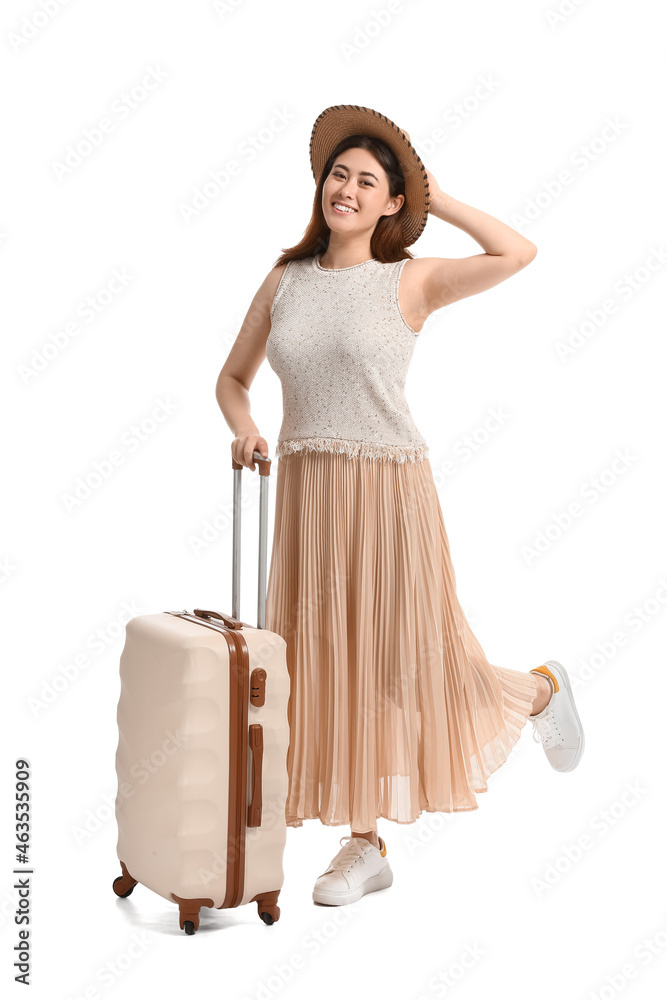 Wall mural Young woman with suitcase on white background