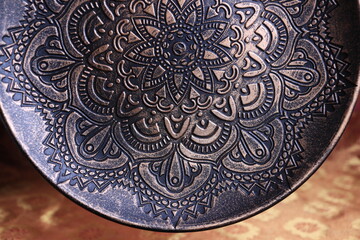 Bronze plate in oriental style on a background of dark red and gold, a magnificent century