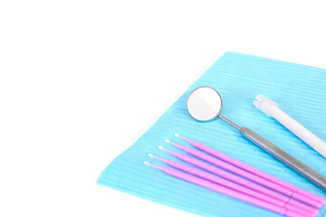 Dental instruments, microbrushes lie on a white table on a napkin. Care and prevention concept. Copy space for an inscription.