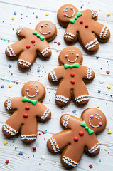 Fototapeta na wymiar Christmas gingerbread men on a white wooden background.