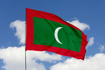 Maldives flag isolated on the blue sky background. close up waving flag of Maldives. flag symbols of Maldives. Concept of Maldives.