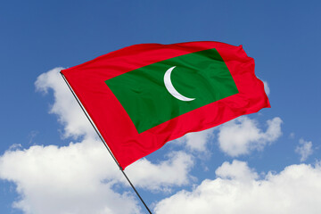 Maldives flag isolated on the blue sky background. close up waving flag of Maldives. flag symbols of Maldives. Concept of Maldives.