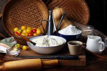 Pumpkin, tomatoes, cottage cheese, starch, salt, soy sauce, sesame and vegetable oil on a wooden table