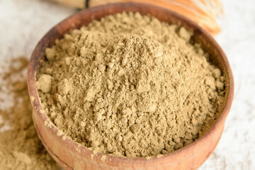 Bowl with hojicha powder on light background, closeup
