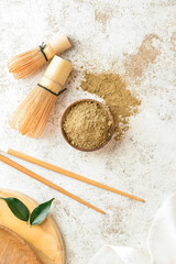 Bowl with hojicha powder and chasen on light background