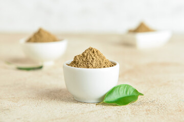 Bowls with hojicha powder on light background