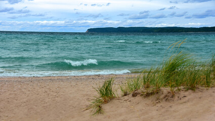 a stunning view across the turquoise-colored water of lake michigan  from the beach at sleeping ...