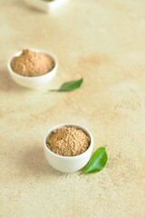 Bowls with hojicha powder on light background